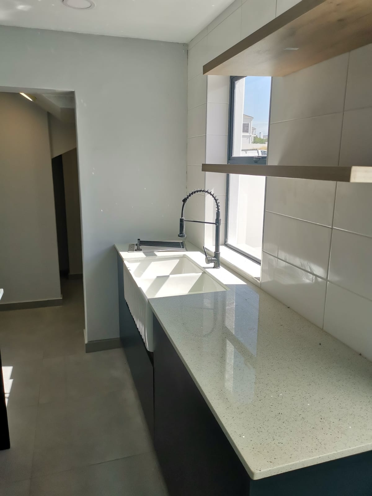 Wooden floating shelves installed in a kitchen for open storage