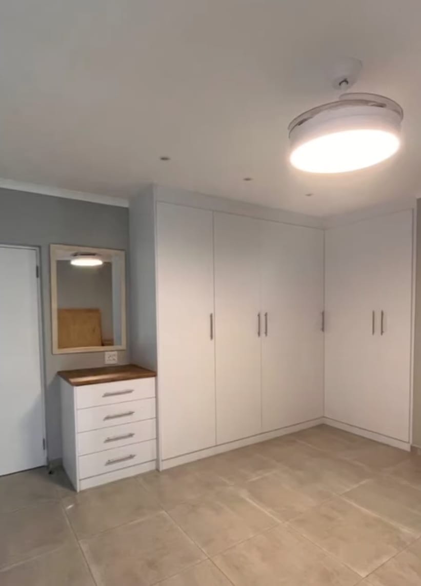 Built-in pantry cabinets with sliding doors in a compact kitchen