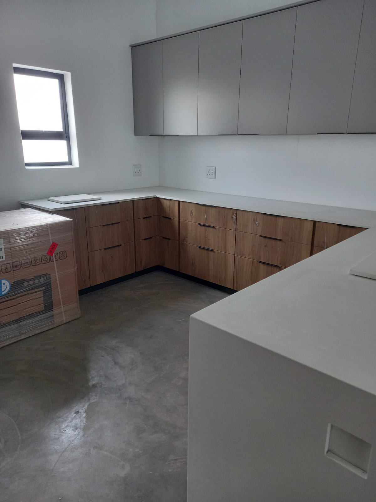 Custom high-gloss white kitchen cupboards in a West Coast home