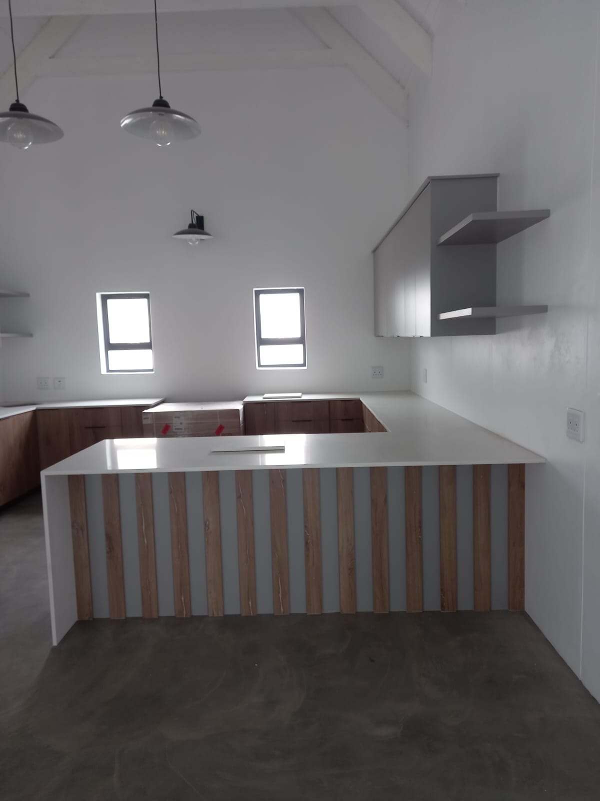 Custom high-gloss white kitchen cupboards in a West Coast home