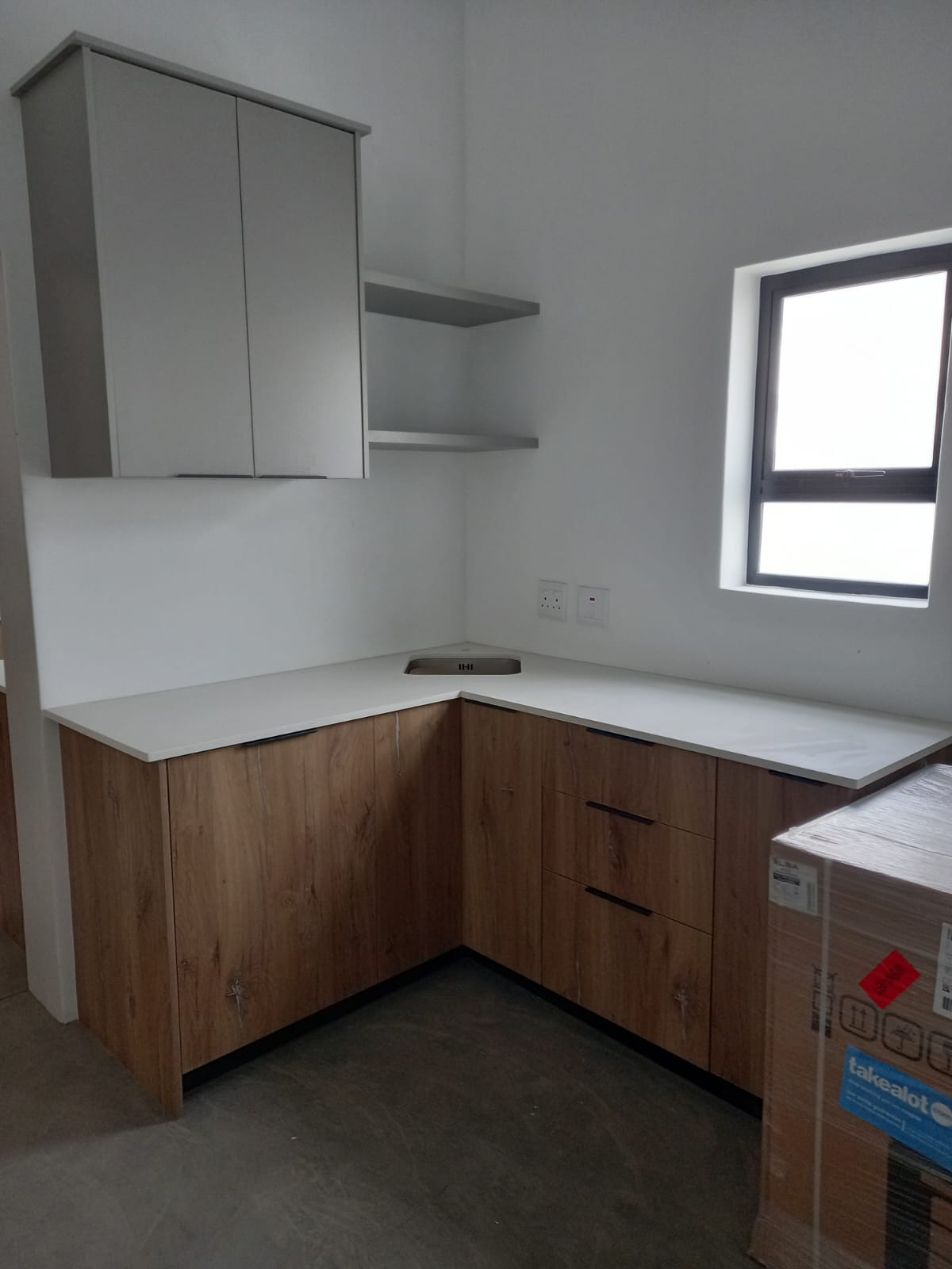 Open-plan kitchen with wooden finishes and white cabinetry