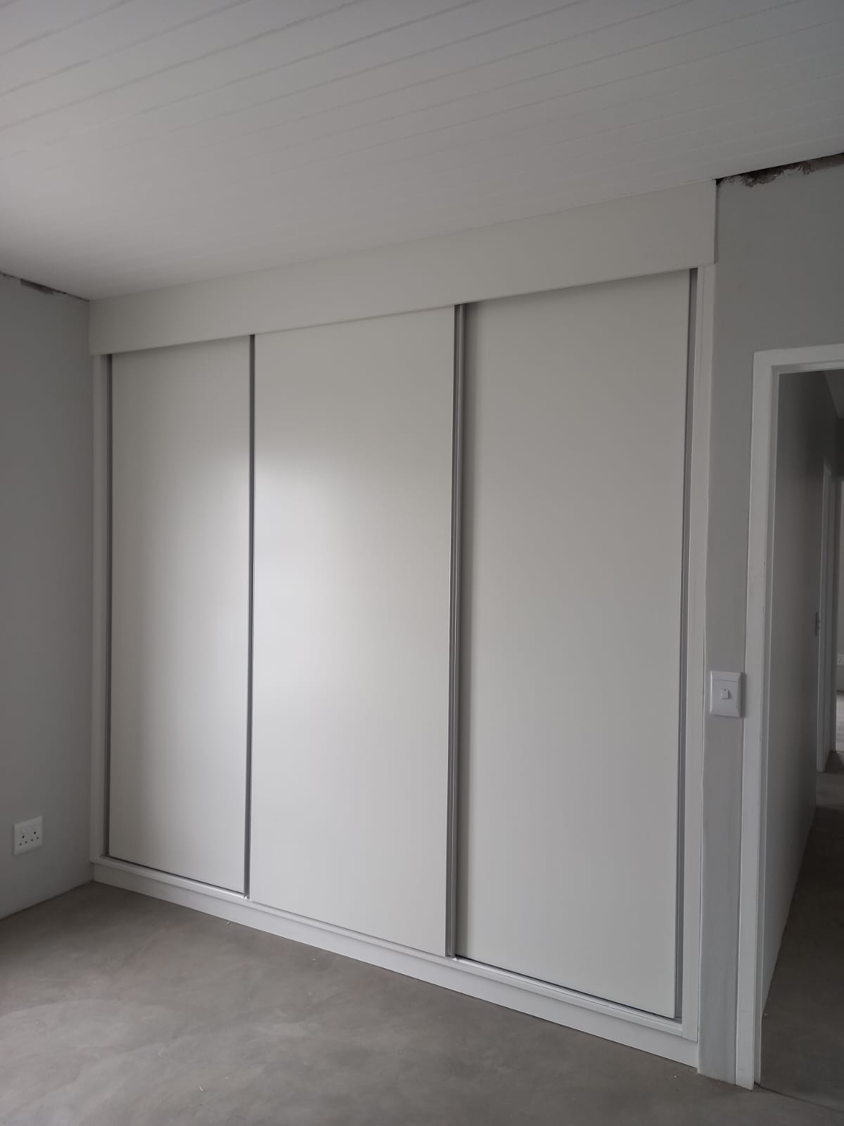 Open-plan kitchen with wooden finishes and white cabinetry