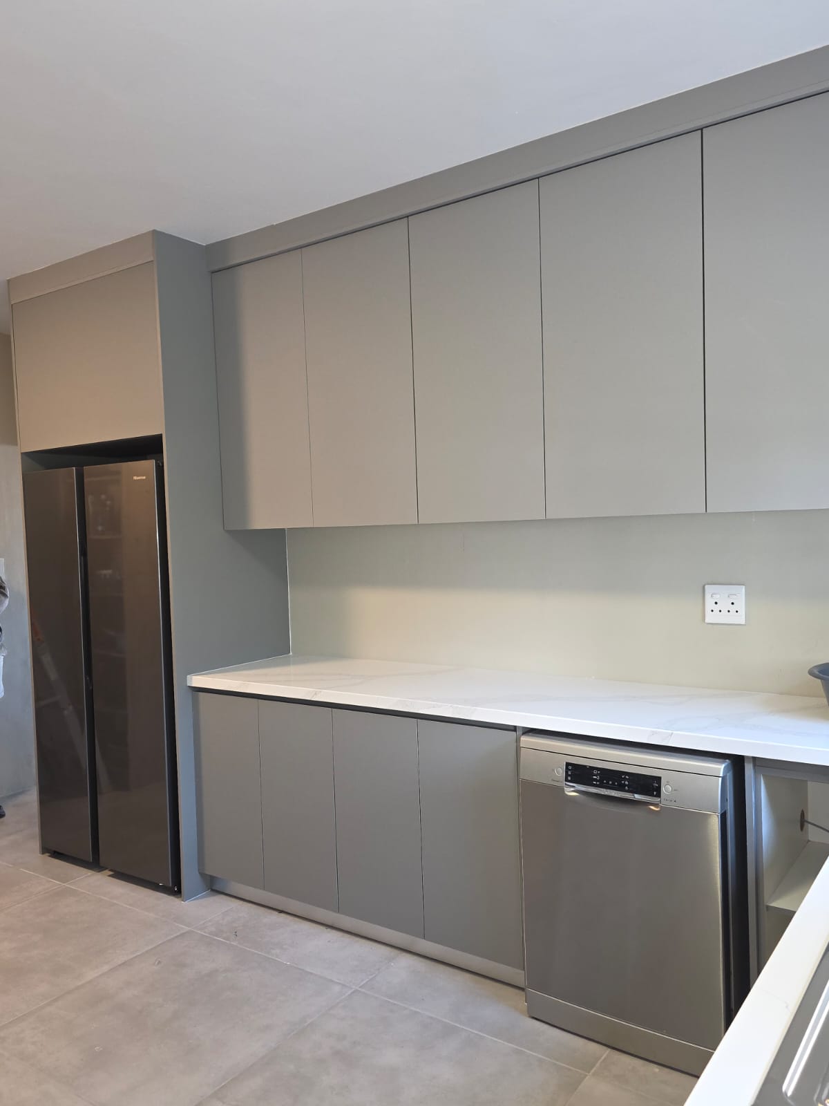 L-shaped kitchen with custom cupboards and under-cabinet lighting