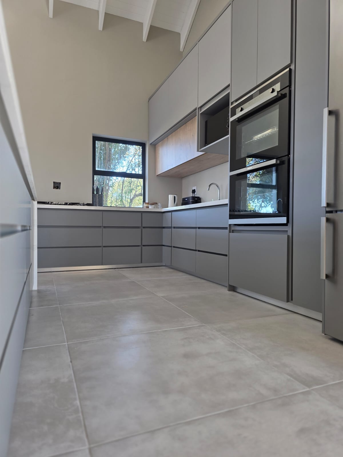 Built-in rustic wood grain cupboards in a Langebaan kitchen